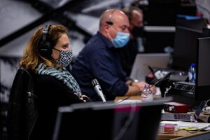 Livestream Production of hybrid event, technicians and director behing control panel