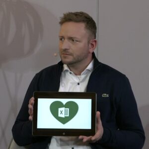 Guy shows tablet with Xcel-logo - his hobby